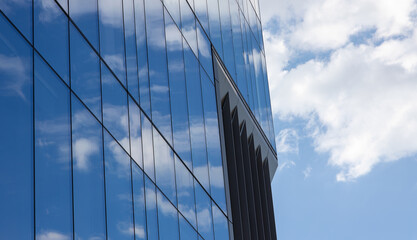Fototapeta na wymiar Blue sky reflection in the glass facade of a building. Cherry Creek district, Denver, Colorado