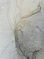 Alcohol ink abstract drawing grey and gold background 