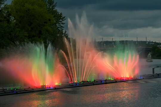 Evening view to Musical fountain with laser animations Roshen on the Southern Buh river in Vinnytsia, Ukraine. May 2021