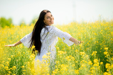 Young woman in the rapeseed field