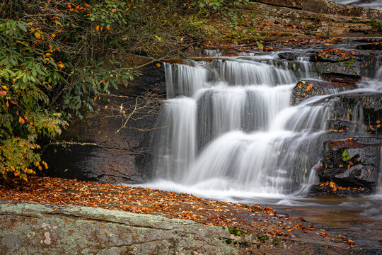 Portion of Carson Creek Falls surrounded by colorful leaves