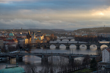 Fototapeta na wymiar View of the bridge at sunset in Prague from the park