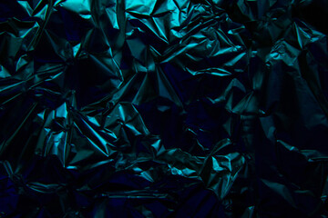 Foil background. Crumpled foil. Abstract background. Wallpaper. Blue and black