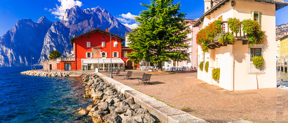Beautiful lake  Lago di Grada. Panoramic view of Torbole village with colorful houses . Italy, Trento