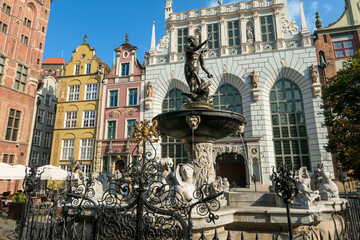 The Neptune's Fountain in Old Town of Gdansk, Poland. The fountain is located in the central point. Town Hall building in the back. City tour. Clear and bright day. © Chris