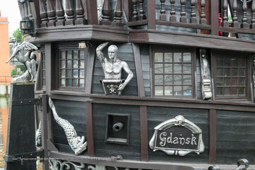 Close up view on the aft of a black ship, docked on the river in Gdansk, Poland. The ship is...