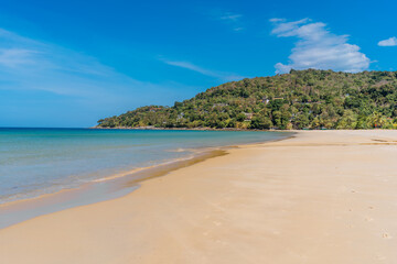 Idyllic tropical Karon beach with white sand, turquoise ocean water and blue sky at Phuket