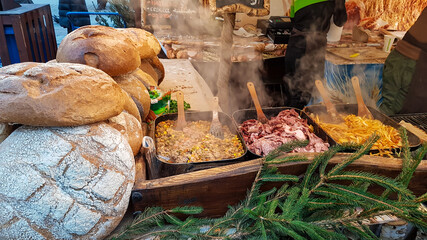 A wooden stand filled with home baked bread and Polish cuisine specialities, like fried sausage,...