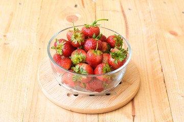 Strawberry in glass bowl on wooden background
- 434369272