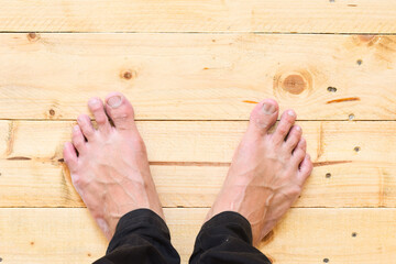 Barefoot on wooden pallet texture