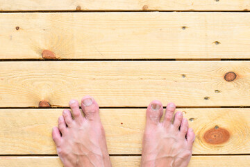 Barefoot on wooden pallet texture