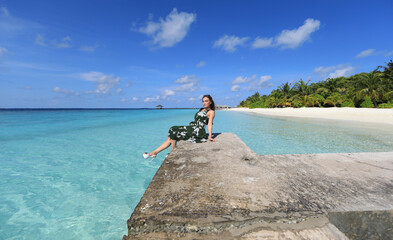 beautiful girl in dress on a tropical sea resort