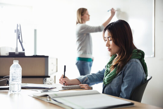 Female Students Working In Classroom At College Campus