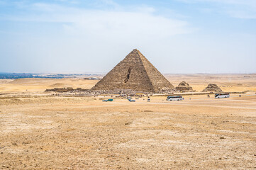 Fototapeta na wymiar Pyramid of Menkaure. Pyramid of Menkaure and Pyramids of Queens, Cairo, Giza. Egyptian desert in Giza. Vacation holidays background