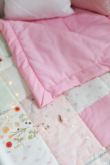 Obraz na płótnie Canvas Pink patchwork blanket. Baby bedding. Bedding and textile for nursery. Nap and sleep time