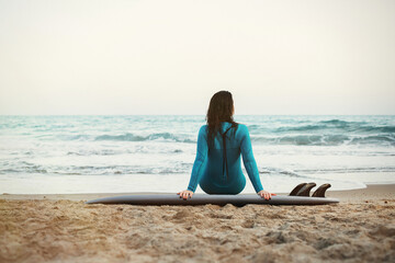 Surfer girl walking with board on the sandy beach. Surfer female.Beautiful young woman at the beach. water sports. Healthy Active Lifestyle. Summer Vacation. Extreme Sport