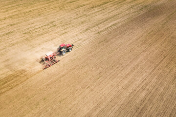 A tractor prepares fields for sowing. Vitl from above