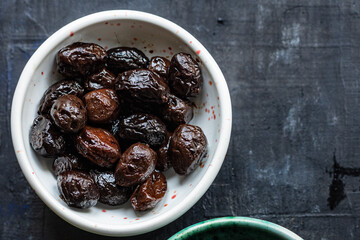 dried olives sun-dried aromatic dry fruit appetizer or salad addition on the table healthy food meal snack copy space food background rustic. top view