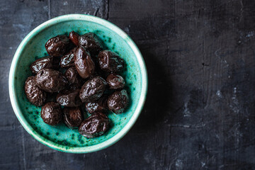 dried olives sun-dried aromatic dry fruit appetizer or salad addition on the table healthy food meal snack copy space food background rustic. top view