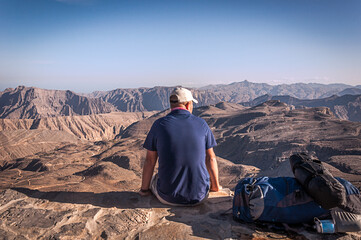 A hikers taking a rest to enjoy the breathtaking view of Jebel Jais in UAE