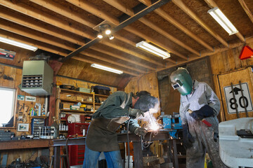 Fototapeta na wymiar Colleagues welding at workshop