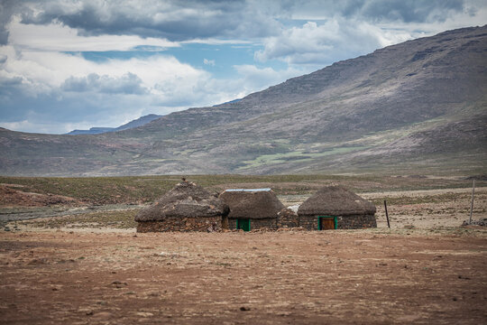 Sani Pass, Lesotho, Africa - 11-30-2020 shephards settlement with straw covered houses the arid landscape of Drakensberg mountain range in Lesotho, Africa
