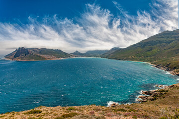 panaramic view on Hout Bay, the southern Harbor of Cape Town, with characteristic table cloth clouds rolling over the mountains,South Africa, landscape
