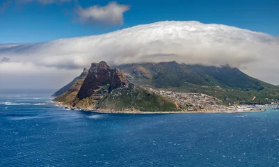 Foto auf Leinwand panaramic view on Hout Bay, the southern Harbor of Cape Town, with characteristic table cloth clouds rolling over the mountains,South Africa, landscape  © Uwe