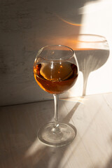 glass of rose wine in sun light and shadow