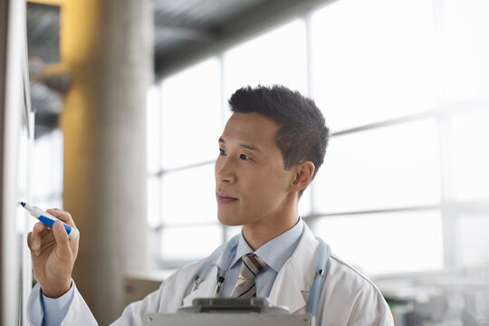 Medical Professional Making Notes On Whiteboard