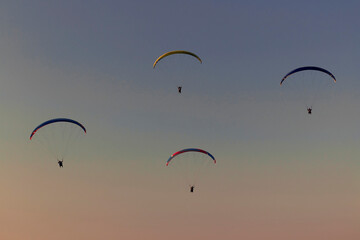 Paragliding from a mountains on an autumn evening 