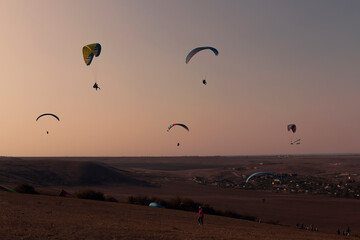Paragliding from a mountains on an autumn evening 