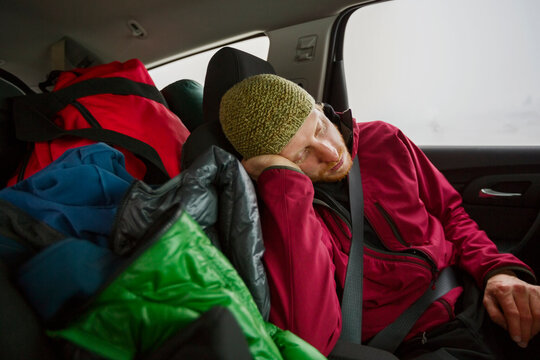 Man Sleeping In Backseat Of Car