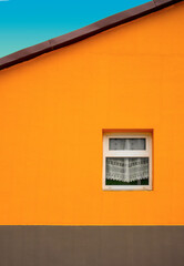 A orange house with white window