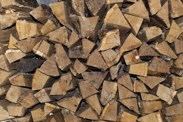 Dry chopped firewood in a bunch. Stack of firewood for kindling