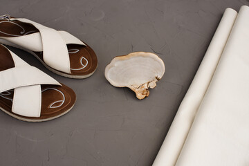 Concept of mushroom leather - white mushroom, eco friendly leather and woman sandal shoes. Vegan leather from mushroom mycelium 