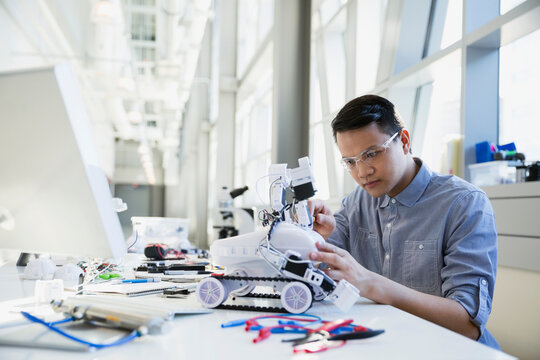 Focused Engineer Assembling Robotic Car