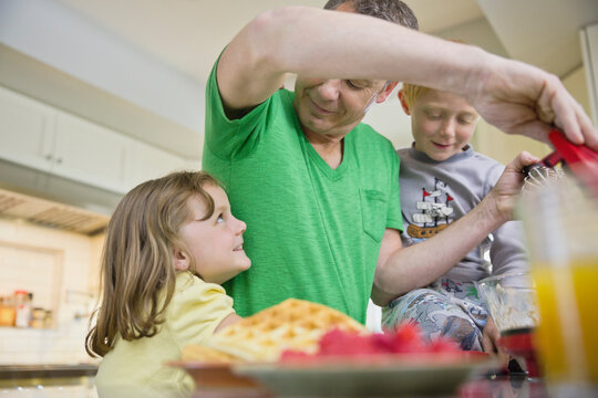 Father Making Waffles With His Kids