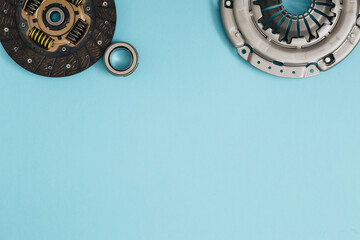 Automotive clutch mechanism, disc, basket and bearing for auto on a blue background.