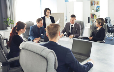 Group of young successful businessmen lawyers communicating together in a conference room while working on a project
