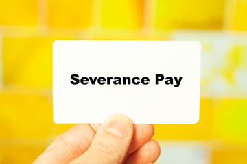 Severance Pay. Financial text in male hand on yellow background at home