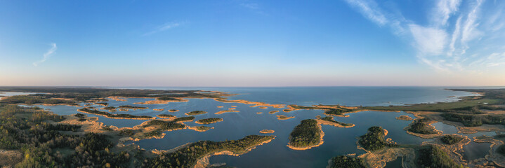 Aerial panoramic view to the amazing sunset colored coastal seascape with the complex lagoon archipelago pattern on Saaremaa island, Estonia