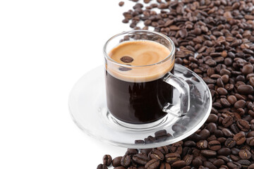 Glass cup with aromatic coffee and pile of beans on white background