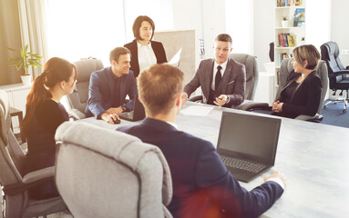 Group of young successful businessmen lawyers communicating together in a conference room while working on a project