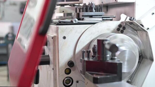 Close up view of worker operating a high precision turning operation on a multi axis lathe, CNC machine tool. High quality 4k footage