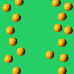 Fruit pattern made of fresh oranges on green pastel background. Top view. Copy space. Pop art design, creative summer concept.
