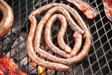 Traditional South African Boerwors sausage cooks on a Braai, or South African barbecue..  Durban...