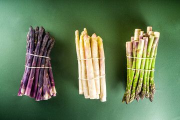 Fresh raw organic asparagus bunch, purple, green and white vegetable 