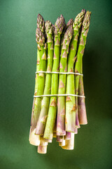 Fresh raw organic asparagus bunch, purple, green and white vegetable 