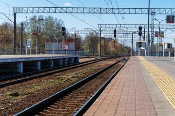 Fototapeta premium Empty railways and railway station, perspective of rails in line, ready for train arriving, railroad infrastructure.